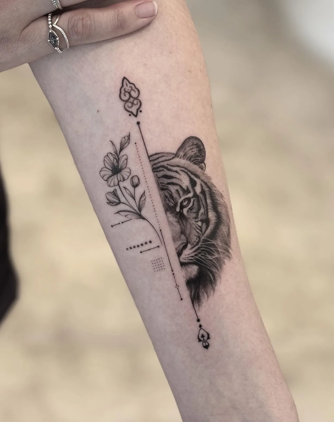 Fine line abstract tattoo on the arm