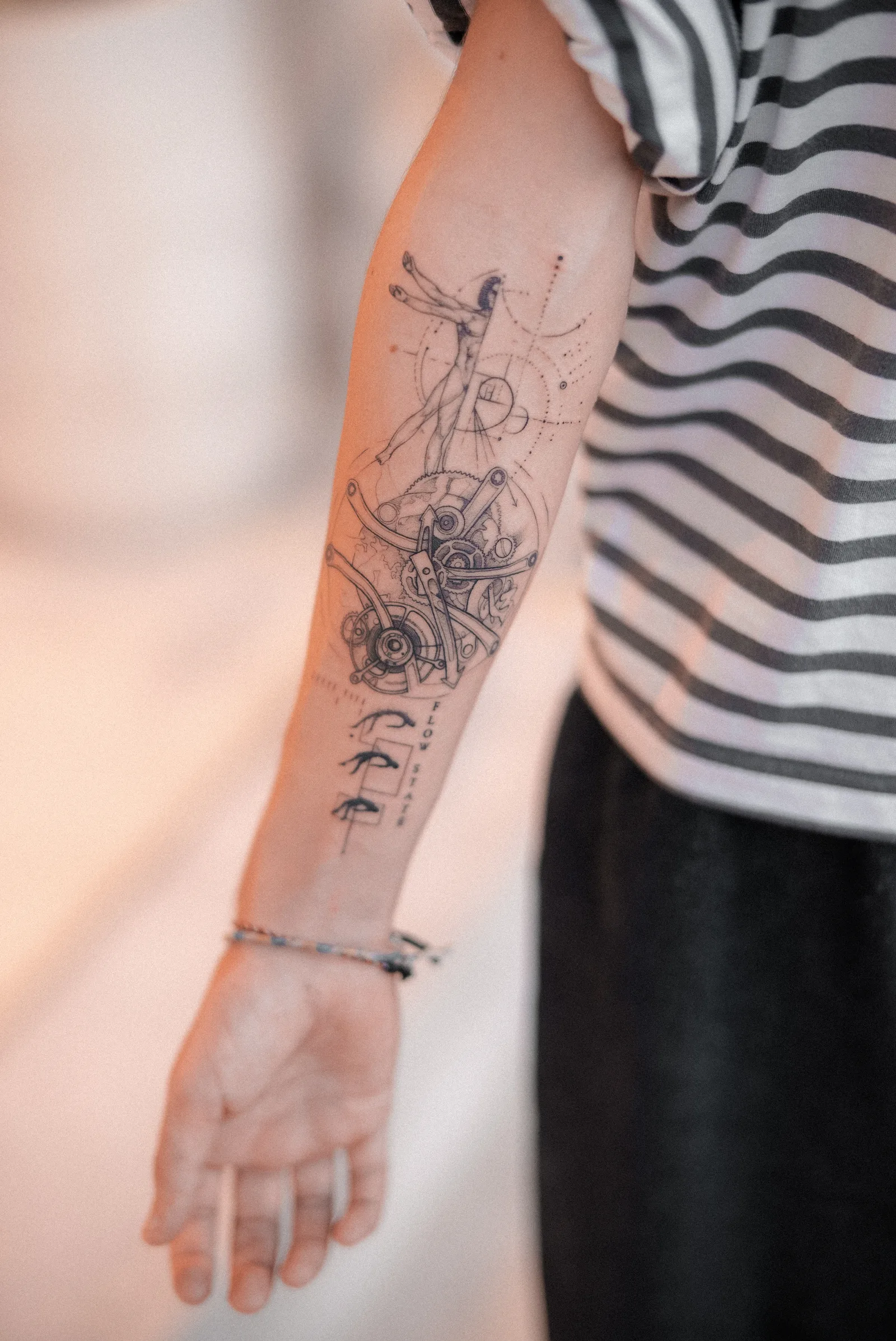Fine line abstract tattoo on the arm