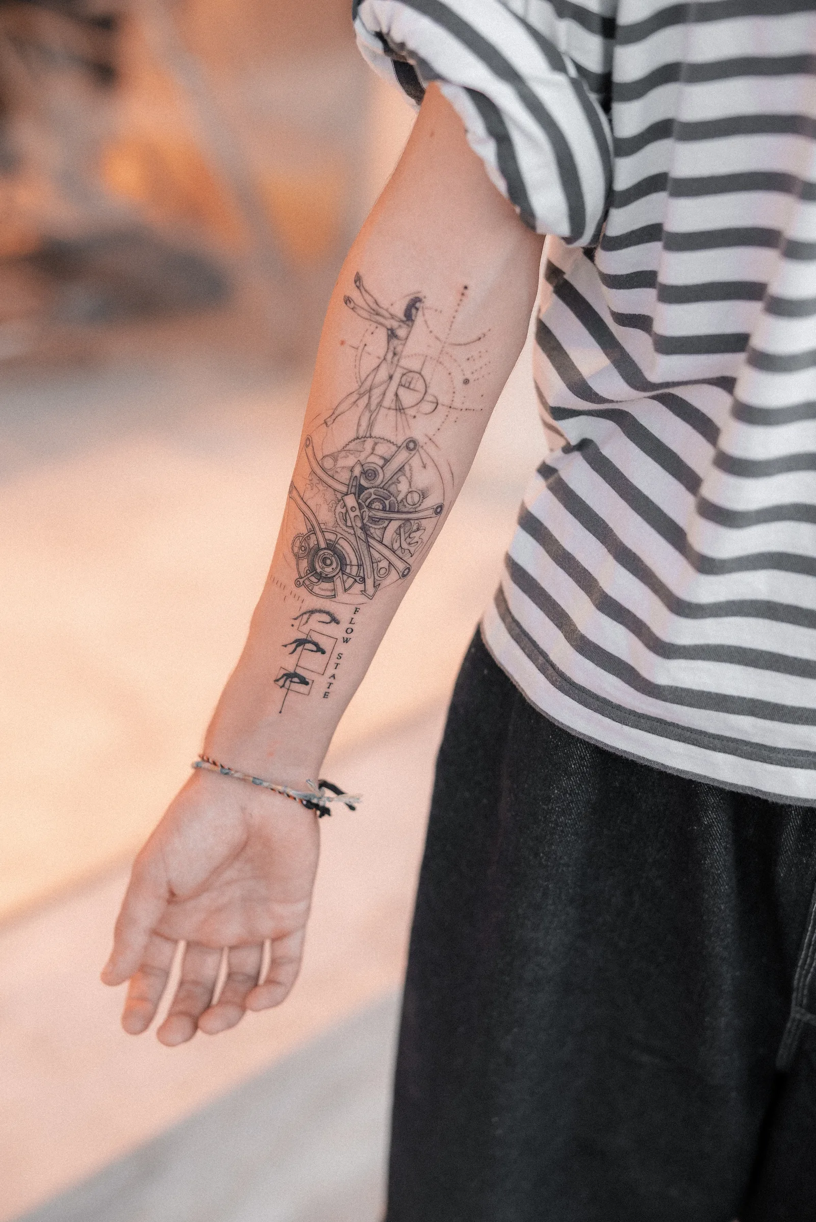 Fine line abstract tattoo on the arm