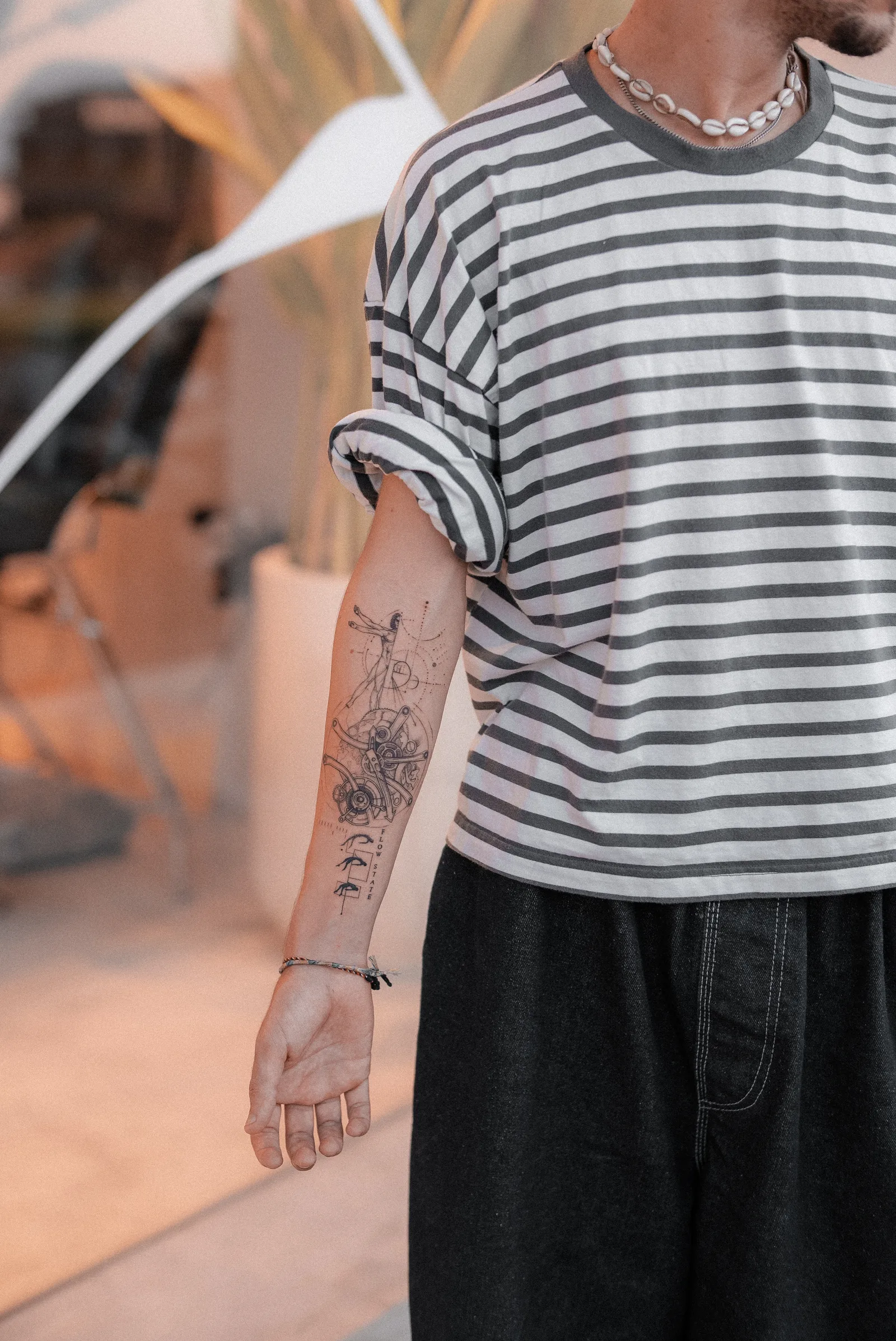 Fine line abstract tattoo on the arm