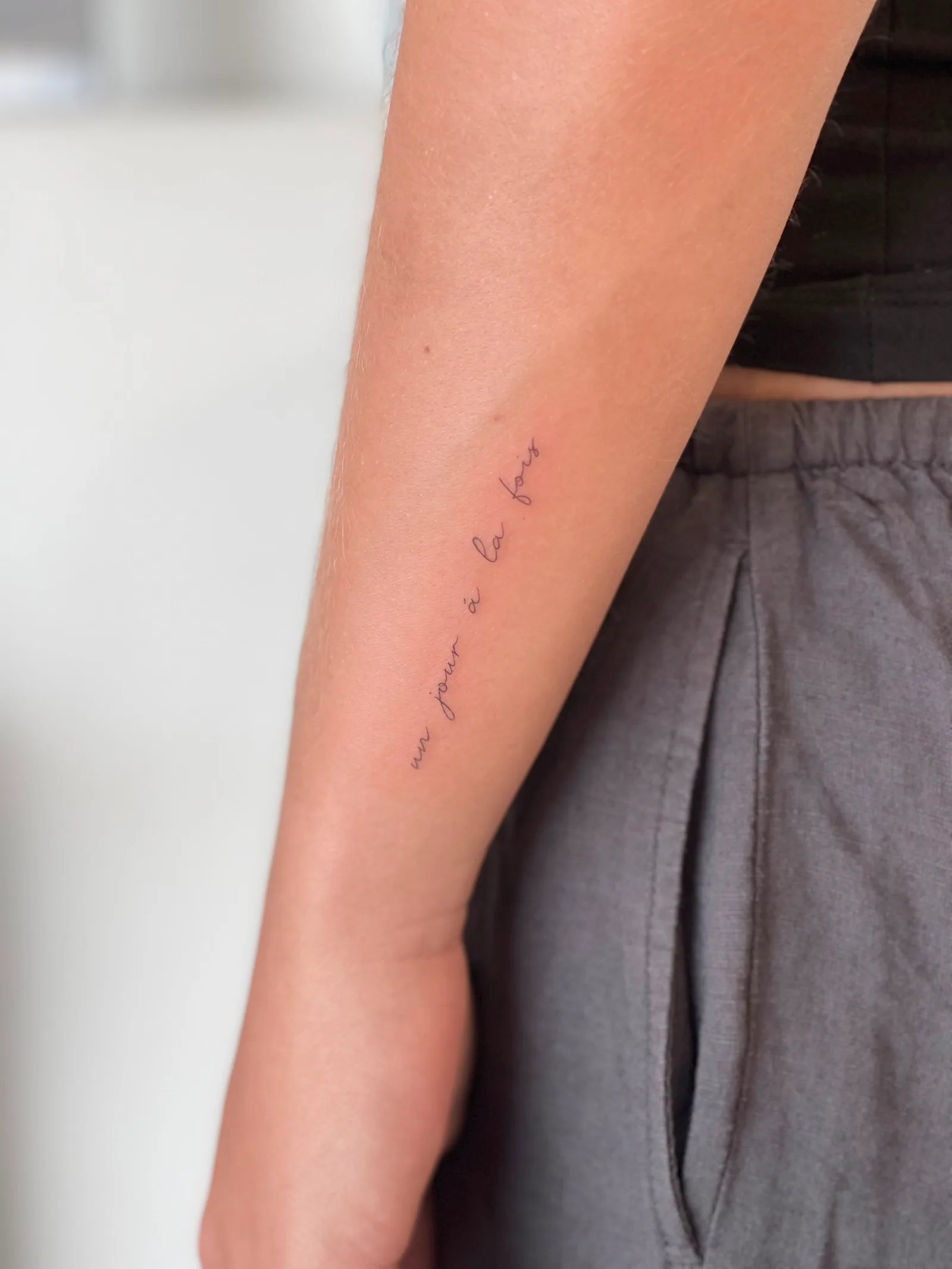 Fine line lettering tattoo on the arm