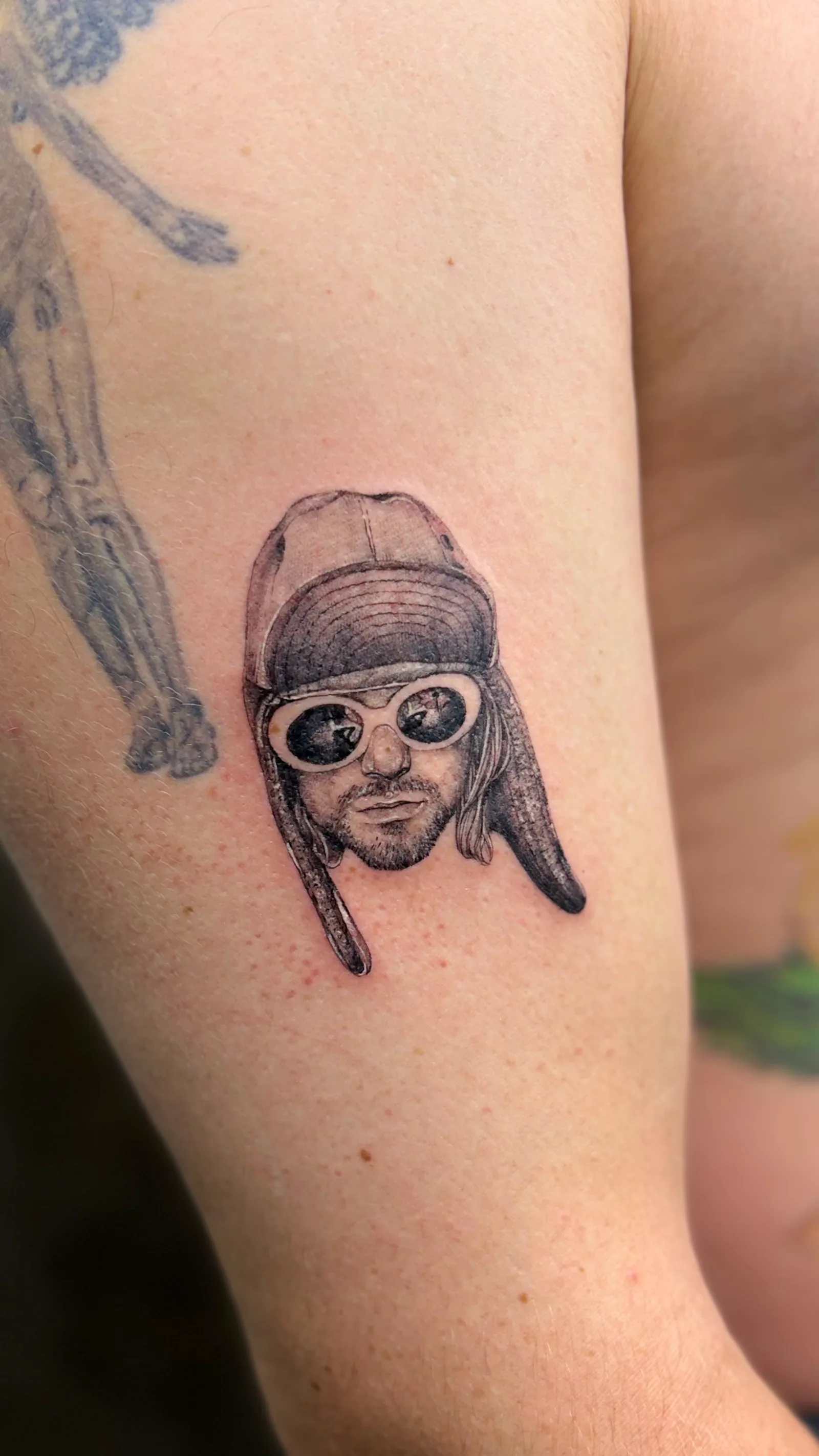 Micro-realism portrait tattoo on the arm