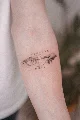 Micro-realism memento mori forearm tattoo