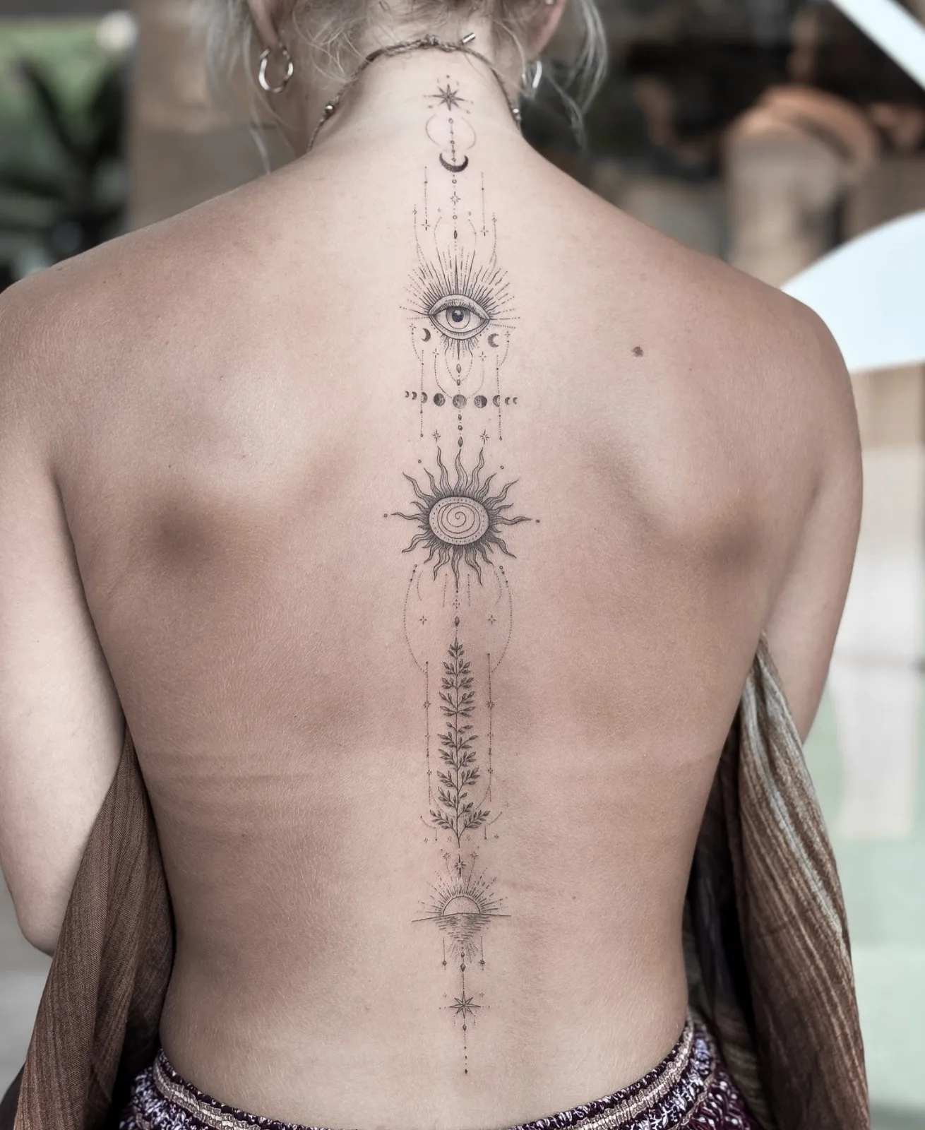 Blackwork & geometric ornamental tattoo on the arm