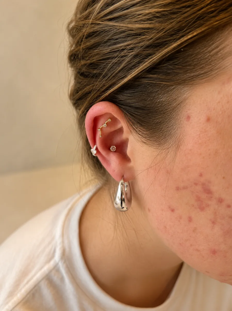 Conch piercing with a stone stud
