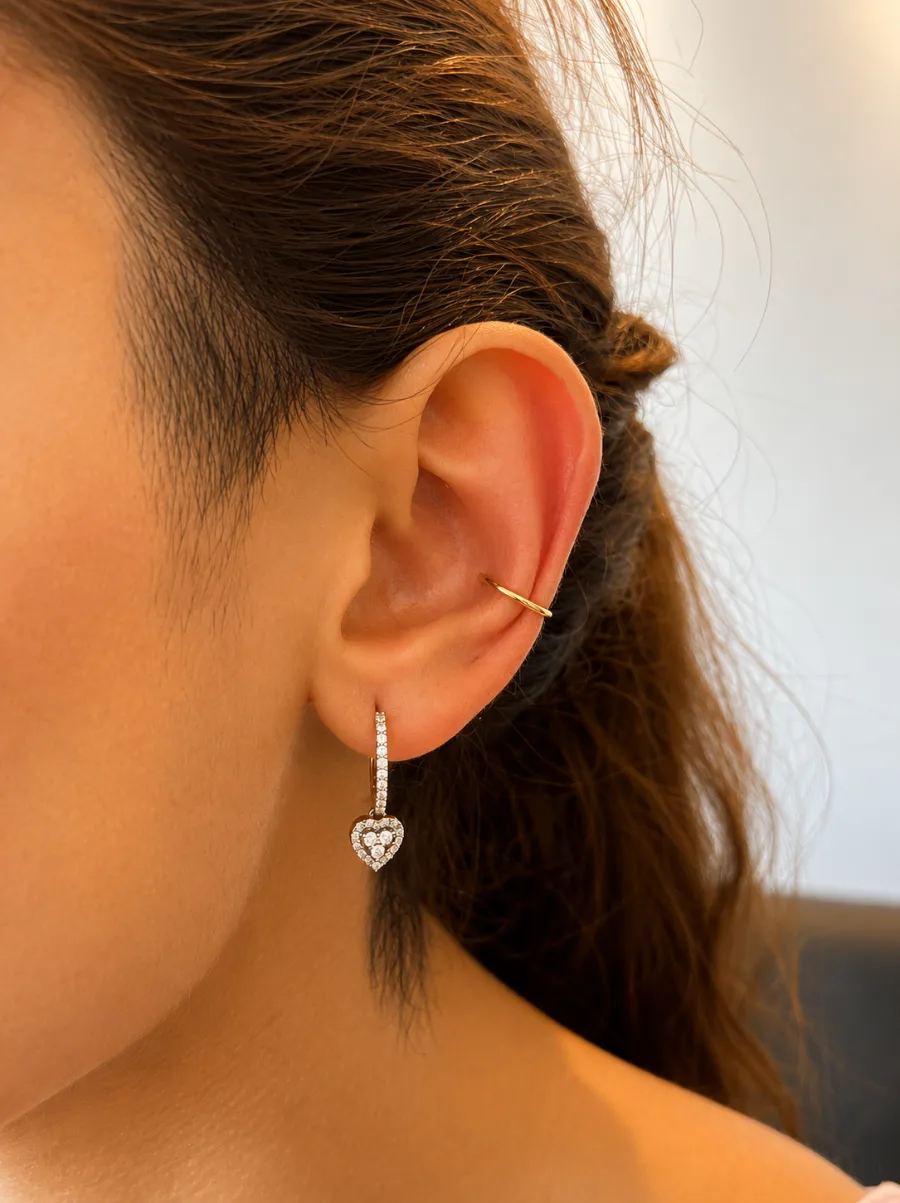 Conch piercing with a fine gold ring