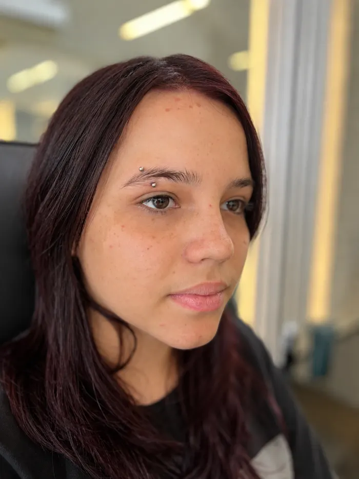 Eyebrow piercing on a client
