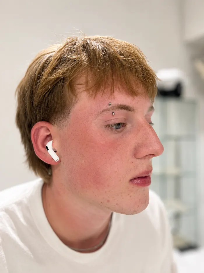 Eyebrow piercing on a client