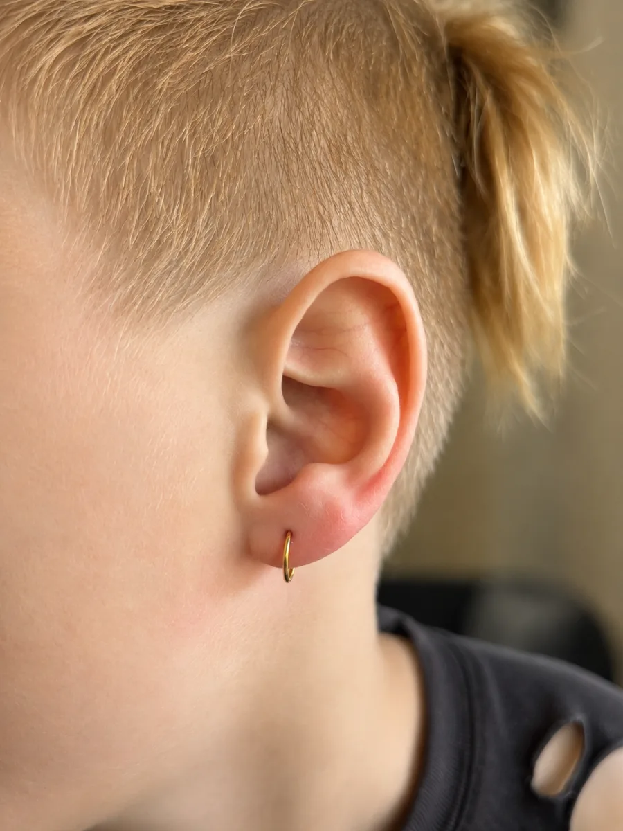 Stacked lobe piercings with gold studs