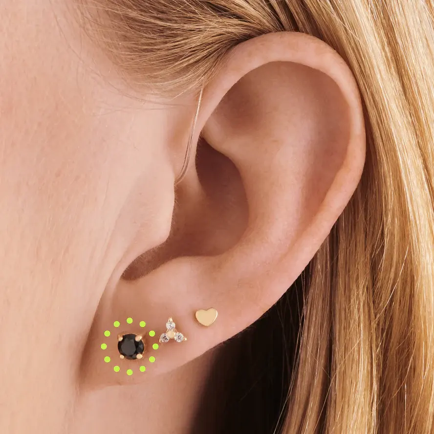Lobe piercing with a gold stud